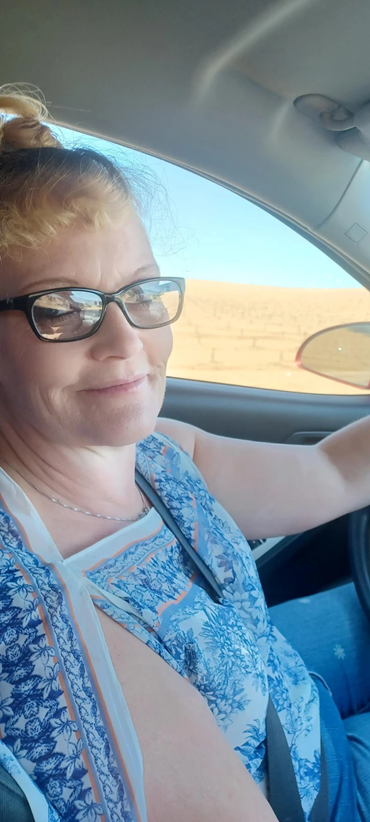 Woman wearing classes driving a car