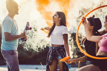 A group of young adults smoking outside