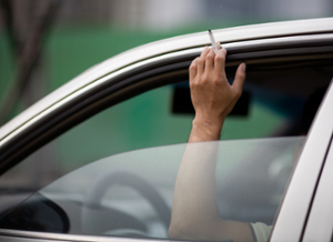 hand holding cannabis out the car window